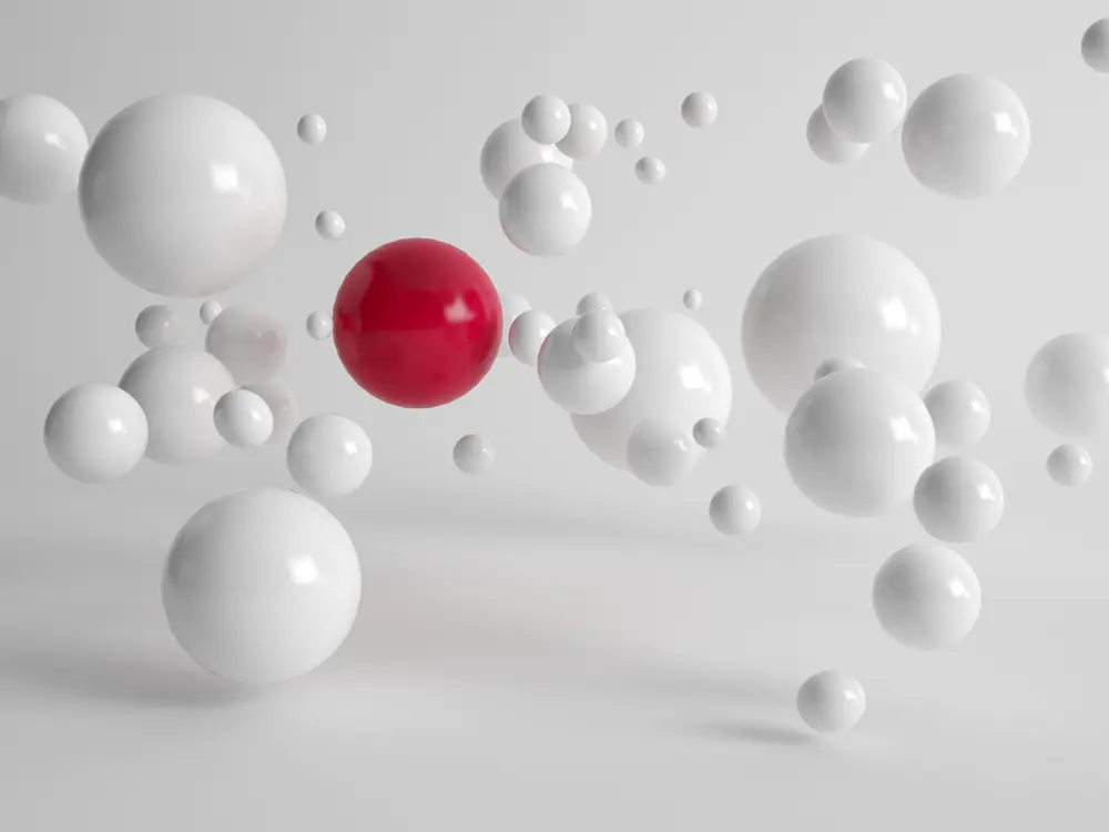 Red and white spheres floating in a minimalist, bright setting, representing material identification and analysis concepts.