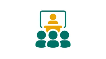 رجل ذو مظهر مهني يرتدي نظارات وقميصًا أزرقًا بنقشة المربعات، ينظر بثقة إلى الكاميرا أمام خلفية محايدة.
